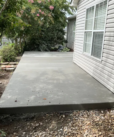Freshly poured concrete slab addition alongside a home in Madison County, Alabama