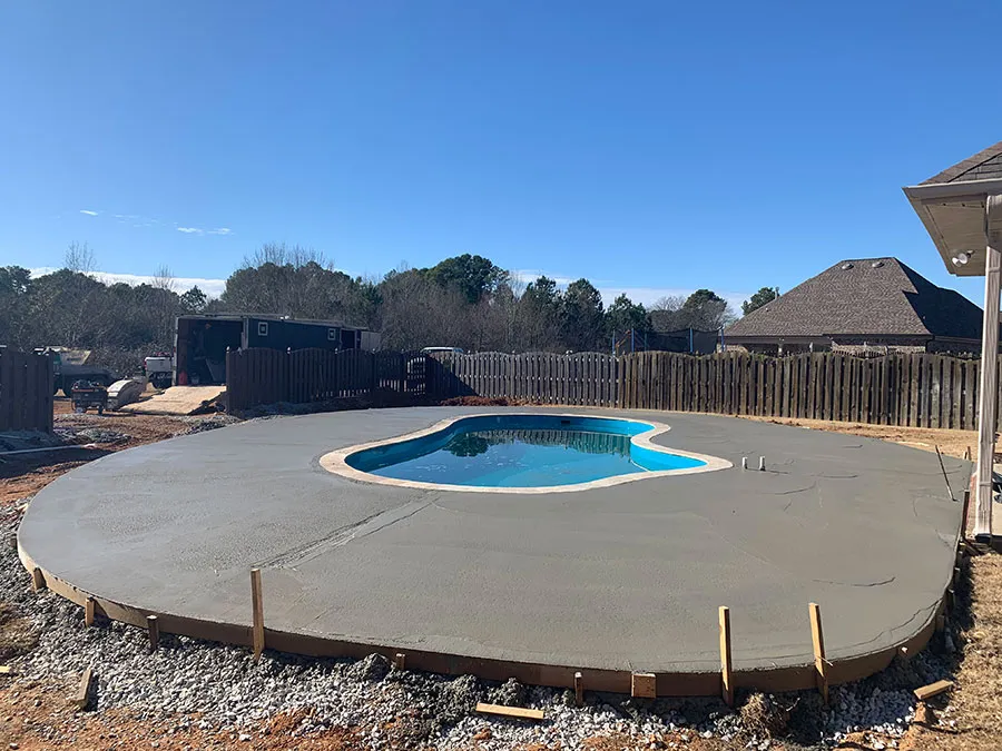 Freshly poured concrete pool deck over a prepared and graded base in North Alabama